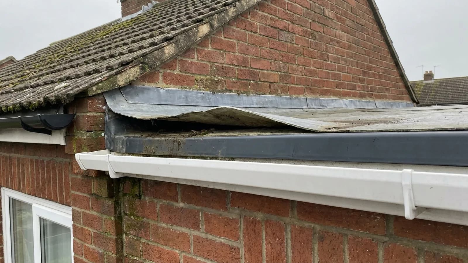 A fibreglass roof edge lifting at the trim