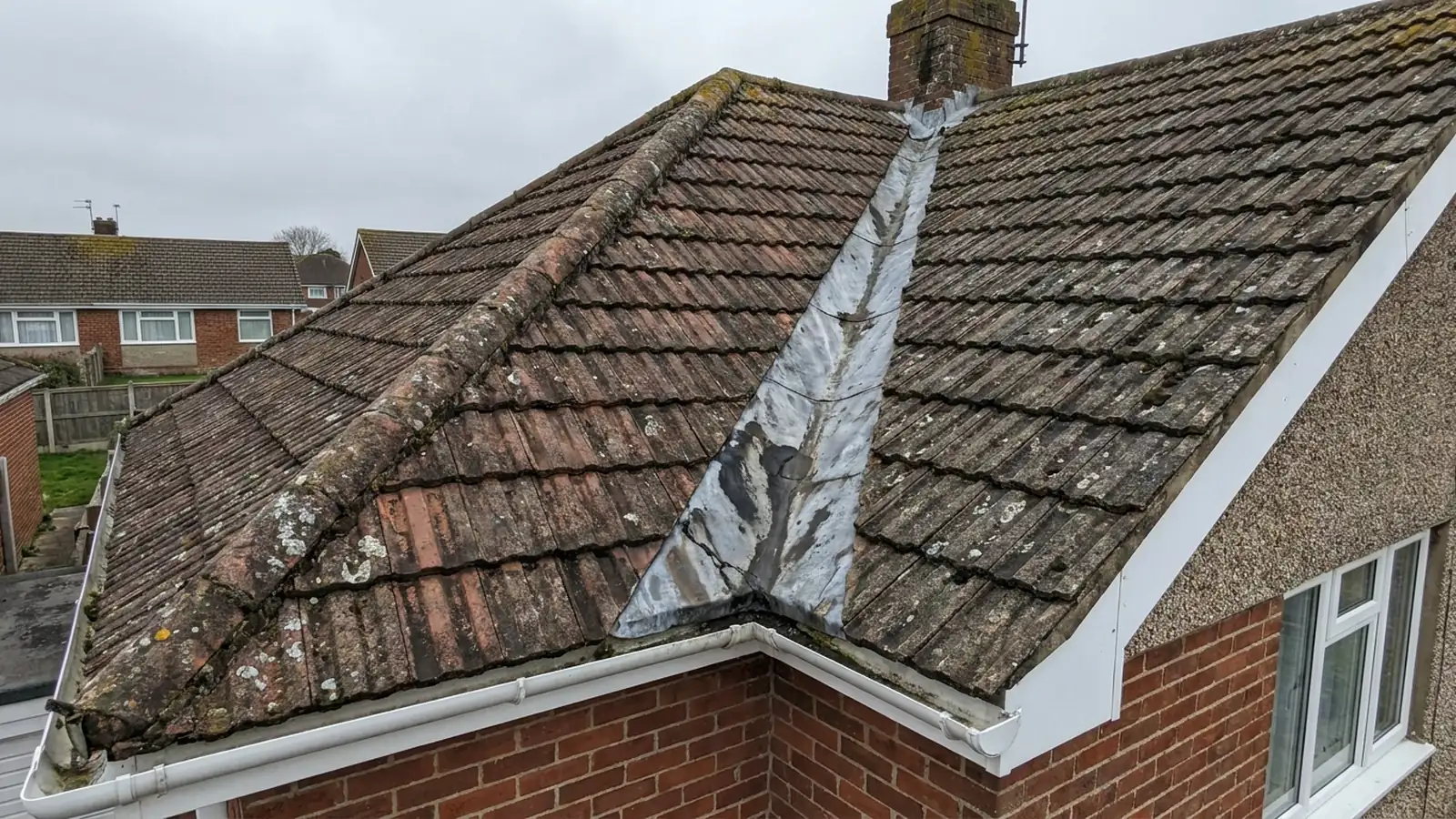 A worn lead valley between two roof slopes
