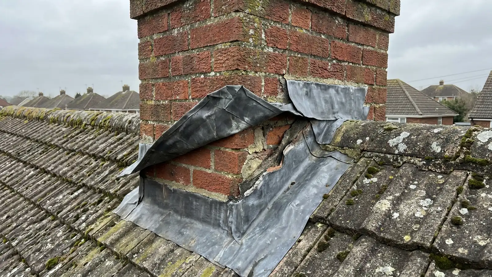Lead flashing peeled away from a chimney